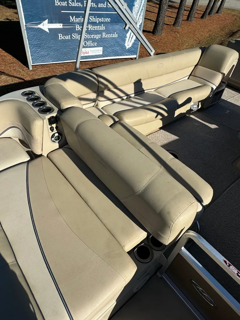 Slide: The Image of 2011 Harris 250GMSE boat interior with beige seating and cup holders. - 5