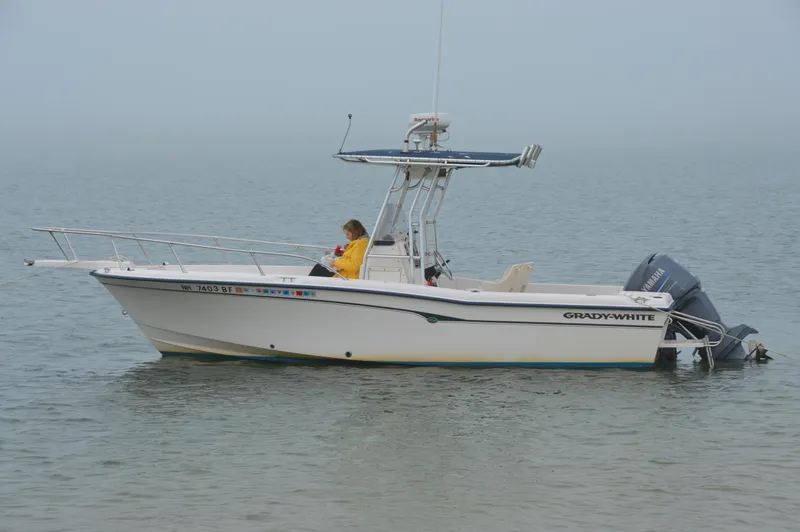 Slide: The Image of Grady-White 222 Fisherman boat from 2000 on calm water with a person onboard. - 0