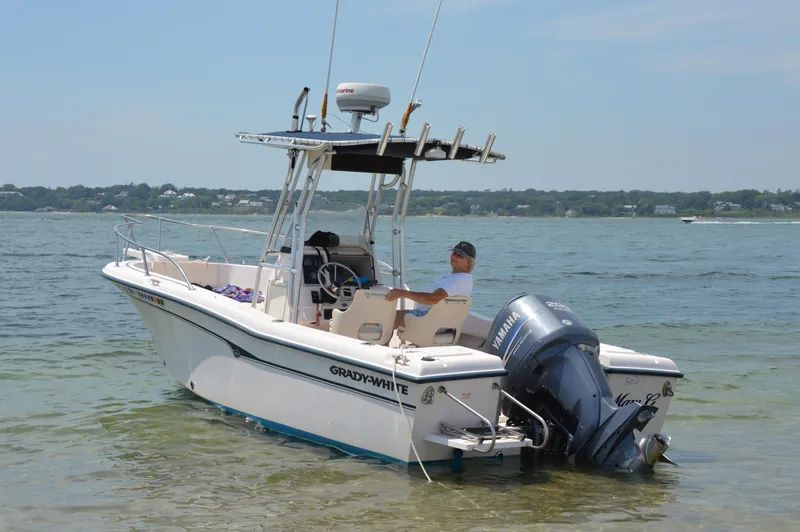 Slide: The Image of 2000 Grady-White 222 Fisherman boat on calm water with Yamaha outboard motor. - 1