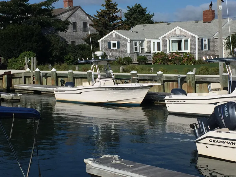 Slide: The Image of Grady-White 222 FISHERMAN boat docked near coastal house, 2000 model. - 2