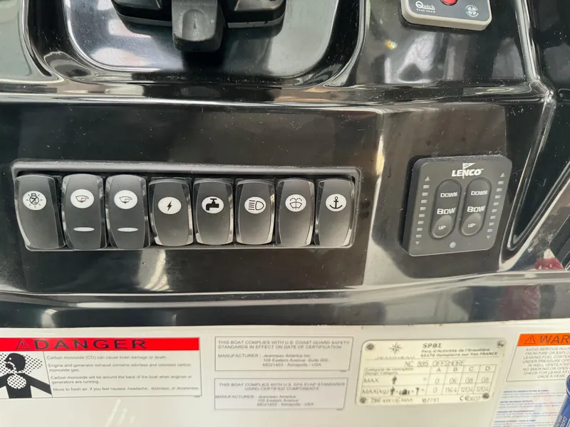 Slide: The Image of Control panel of 2019 Jeanneau NC 895 boat with various switches and warning labels. - 10