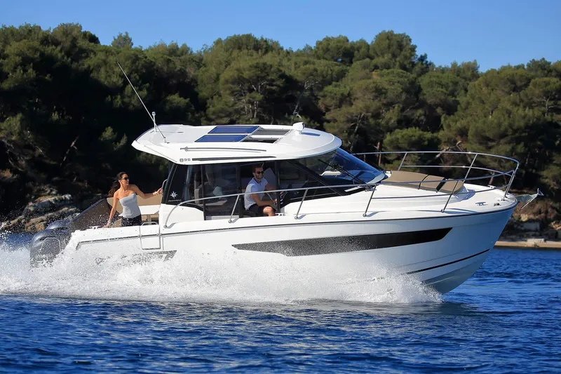 Slide: The Image of 2019 Jeanneau NC 895 cruising on a sunny day with passengers onboard. - 14