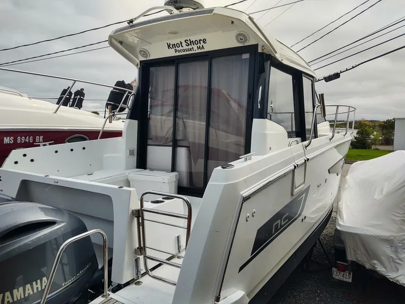 Slide: The Image of 2019 Jeanneau NC 895 boat docked, featuring Yamaha outboard motor. - 2