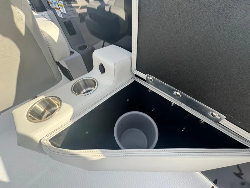 Slide: The Image of 2024 Hurricane FunDeck 2260 RE boat interior with cup holders and storage compartment. - 10