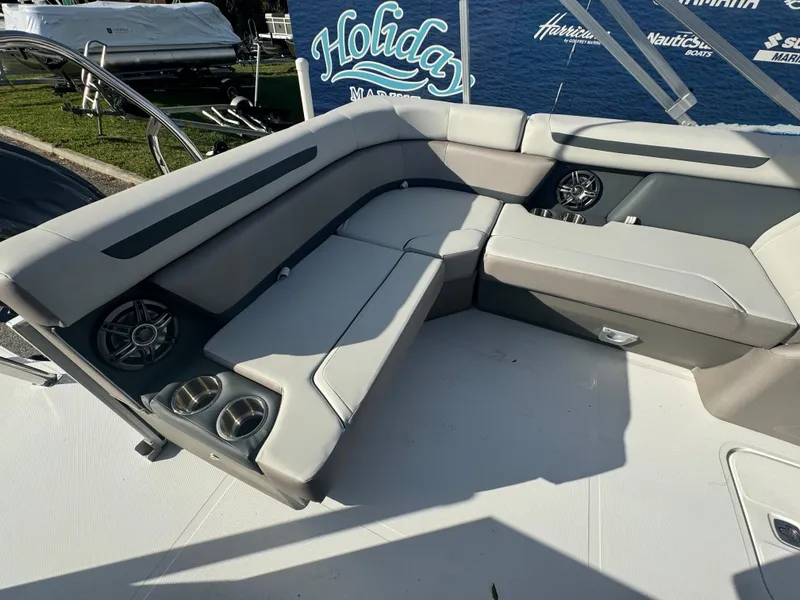 Slide: The Image of 2024 Hurricane FunDeck 2260 RE boat interior with cushioned seating and cup holders. - 11