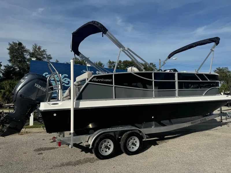 Slide: The Image of 2024 Hurricane FunDeck 2260 RE boat on trailer, featuring Yamaha outboard motor. - 2