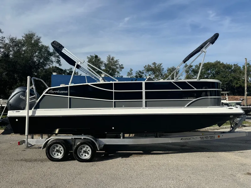 Slide: The Image of 2024 Hurricane FunDeck 2260 RE boat on trailer, parked outdoors under clear sky. - 3