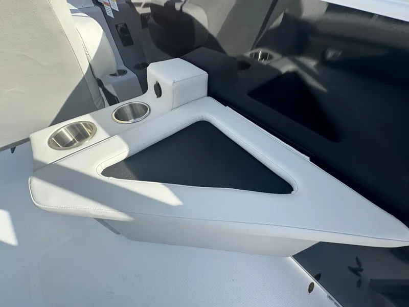 Slide: The Image of 2024 Hurricane FunDeck 2260 RE boat interior with cup holders and seating area. - 9