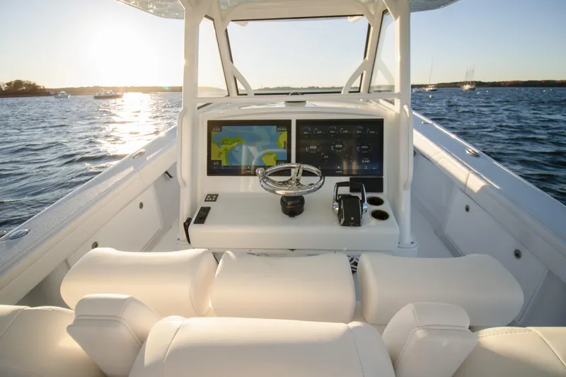 Slide: The Image of 2024 Yellowfin 39 boat cockpit with modern navigation system on open water. - 2