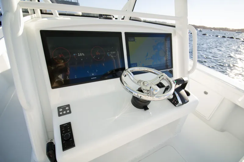 Slide: The Image of 2024 Yellowfin 39 boat dashboard with dual screens and steering wheel. - 3