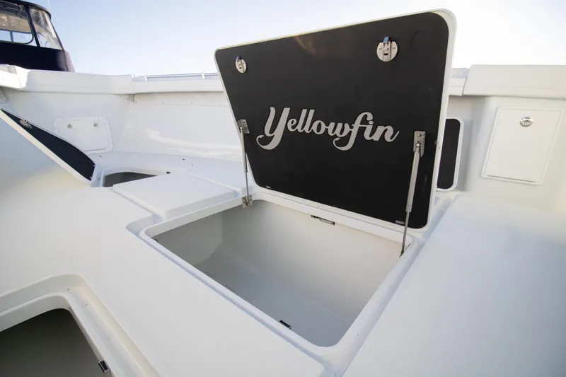 Slide: The Image of 2024 Yellowfin 39 boat storage compartment open, showcasing spacious interior. - 6