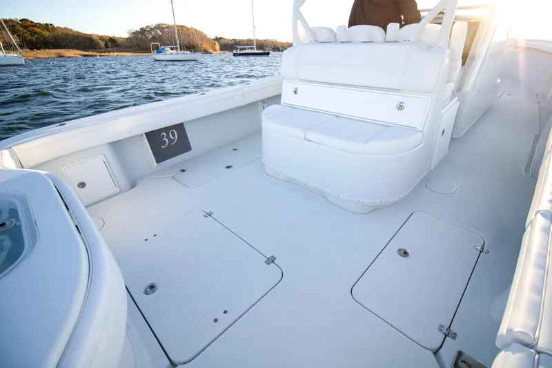 Slide: The Image of 2024 Yellowfin 39 boat deck with white seating and storage compartments. - 9