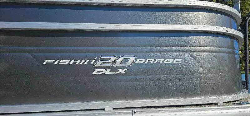 Slide: The Image of 2025 Sun Tracker Fishin' Barge 20 DLX logo on metallic surface. - 2