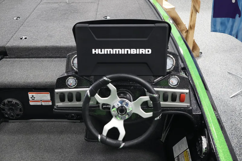 Slide: The Image of 2025 Nitro Z19 boat with green and black seats, displayed indoors. - 12