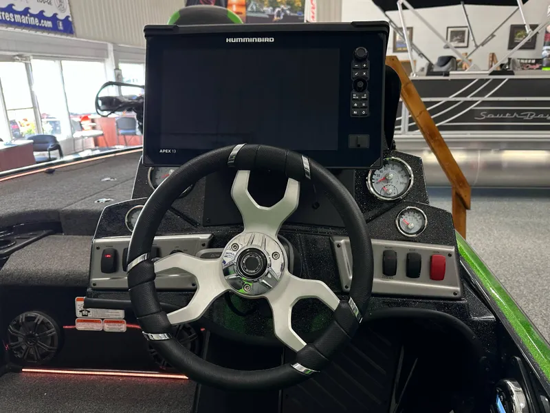 Slide: The Image of 2025 Nitro Z19 boat interior with green accents and Humminbird electronics. - 13
