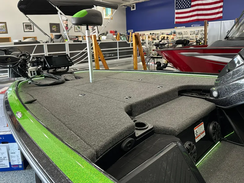 Slide: The Image of 2025 Nitro Z19 boat with green accents on a trailer in a showroom. - 5