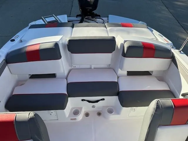 Slide: The Image of 2025 Tahoe T21 boat interior with gray and red cushioned seating. - 14