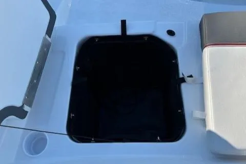 Slide: The Image of 2025 Tahoe T21 boat storage compartment with open lid and adjacent seating. - 19