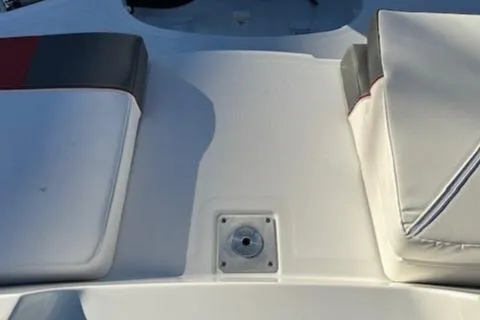 Slide: The Image of 2025 Tahoe T21 boat interior with cushioned seating and deck detail. - 20