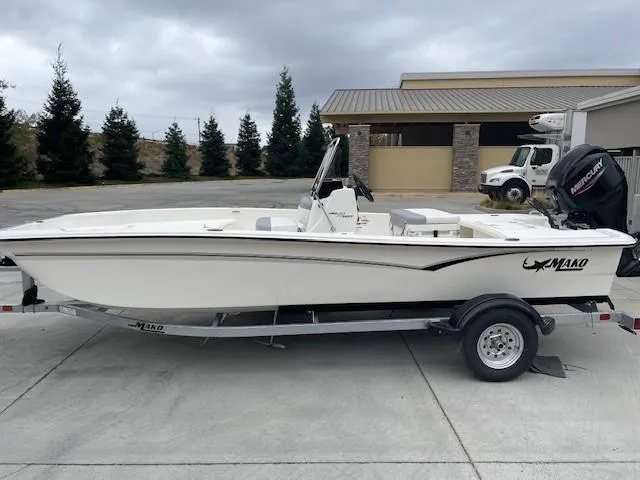 The Image of 2025 Mako Pro Skiff 17 CC boat on trailer, parked outdoors. - 0