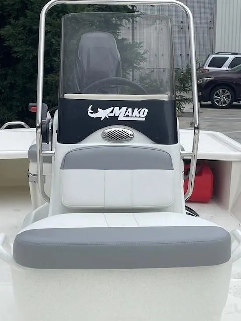 Slide: The Image of 2025 Mako Pro Skiff 17 CC boat, front view, with steering console and seating. - 2