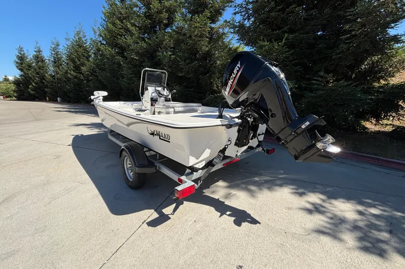 Slide: The Image of 2025 Mako Pro Skiff 17 CC boat on trailer, parked outdoors. - 2
