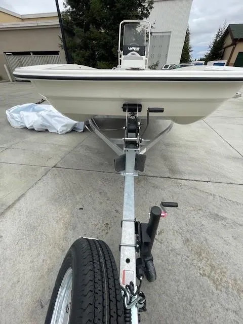 Slide: The Image of 2025 Mako Pro Skiff 17 CC boat on trailer, parked outdoors. - 4