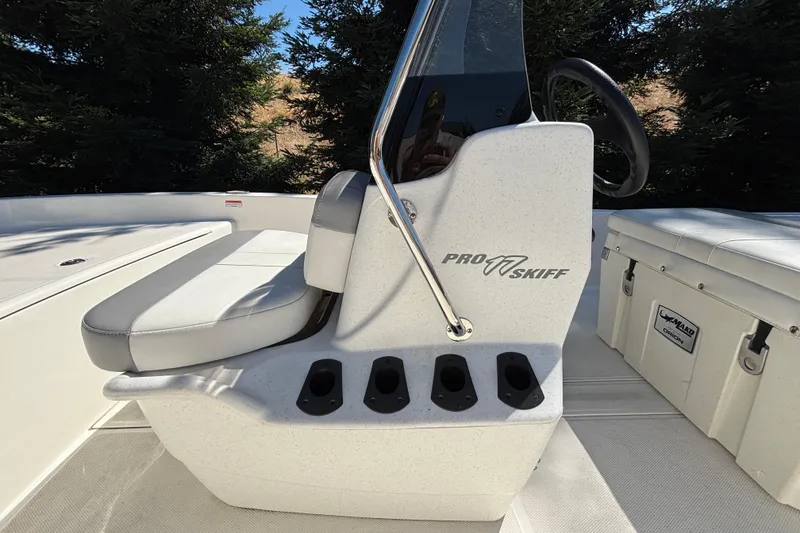 Slide: The Image of 2025 Mako Pro Skiff 17 CC boat interior with seating and storage compartments. - 19