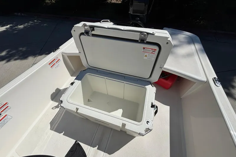 Slide: The Image of Open storage compartment on 2025 Mako Pro Skiff 17 CC boat deck. - 35