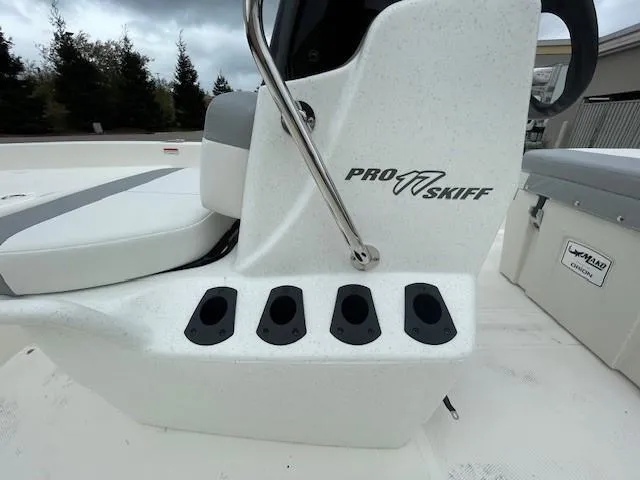 Slide: The Image of 2025 Mako Pro Skiff 17 CC boat console with rod holders and seating. - 5