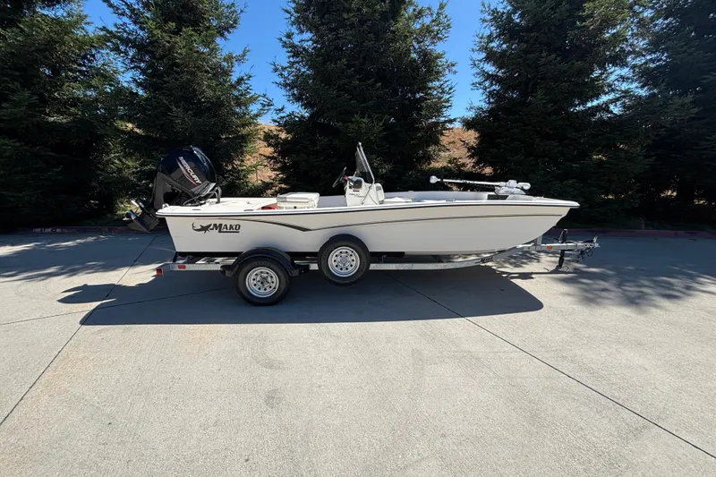 The Image of 2025 Mako Pro Skiff 17 CC boat on trailer, parked outdoors. - 0