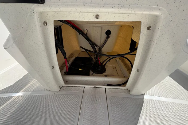 Slide: The Image of Open compartment of 2025 Mako Pro Skiff 17 CC showing wiring and battery setup. - 33