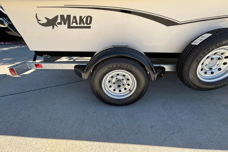 Slide: The Image of Trailer of 2025 Mako Pro Skiff 17 CC boat with visible logo and wheels. - 30