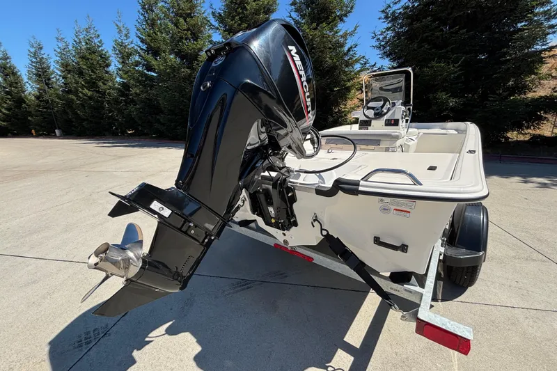 Slide: The Image of 2025 Mako Pro Skiff 17 CC boat with Mercury outboard motor on trailer. - 8