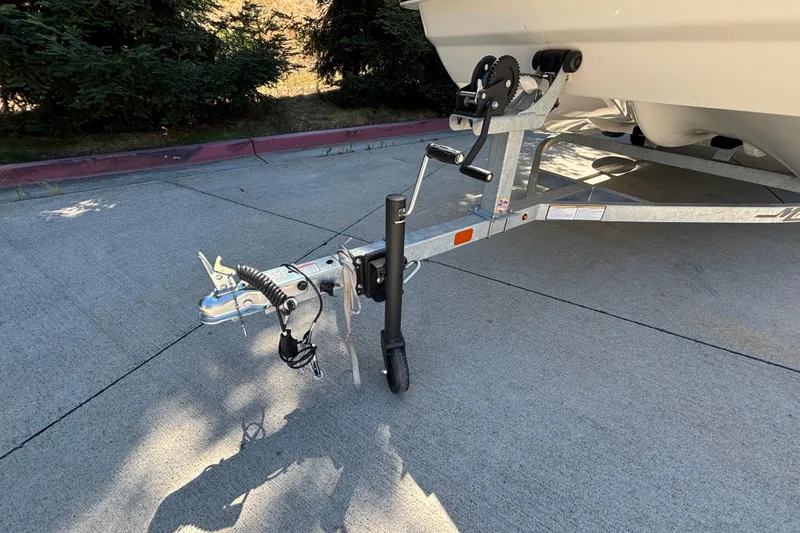 Slide: The Image of Trailer hitch of 2025 Mako Pro Skiff 17 CC boat on pavement. - 6