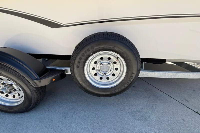 Slide: The Image of Trailer wheel of 2025 Mako Pro Skiff 17 CC on concrete surface. - 29