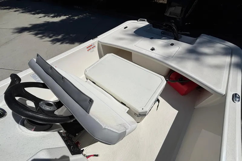 Slide: The Image of Interior view of 2025 Mako Pro Skiff 17 CC boat, featuring steering wheel and seating. - 20