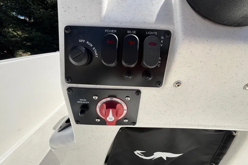 Slide: The Image of Control panel of 2025 Mako Pro Skiff 17 CC boat with switches and main breaker. - 37