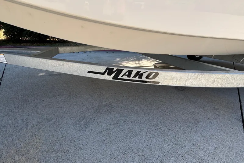 Slide: The Image of 2025 Mako Pro Skiff 17 CC boat trailer on concrete surface. - 24