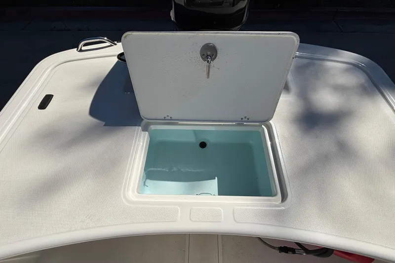 Slide: The Image of 2025 Mako Pro Skiff 17 CC boat with open storage compartment on deck. - 32
