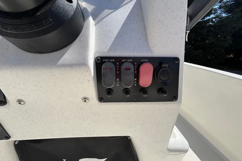 Slide: The Image of Control panel of 2025 Mako Pro Skiff 17 CC boat with switches and 12V outlet. - 36