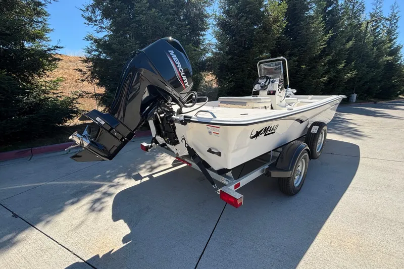 Slide: The Image of 2025 Mako Pro Skiff 17 CC boat on trailer with Mercury outboard motor. - 3