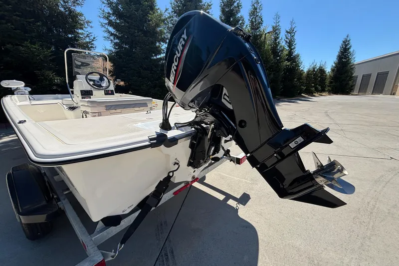 Slide: The Image of 2025 Mako Pro Skiff 17 CC boat with Mercury outboard motor on trailer. - 9