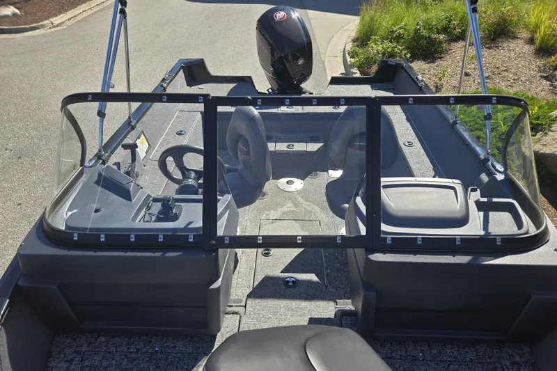 Slide: The Image of 2025 Tracker Pro Guide V-175 WT boat interior with steering console and seating. - 18