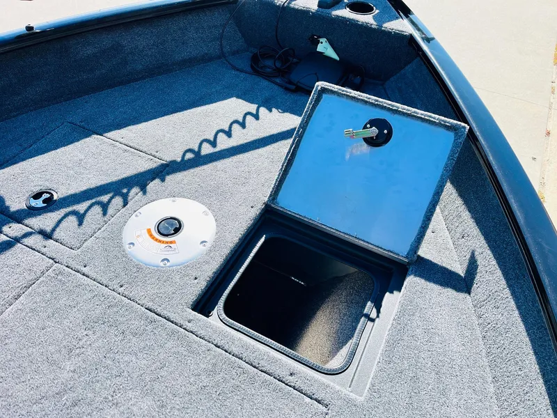 Slide: The Image of 2025 Tracker Pro Guide V-16 SC boat interior with open storage compartment. - 12