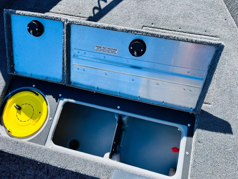 Slide: The Image of 2025 Tracker Pro Guide V-16 SC boat storage compartments with yellow lid and open hatch. - 14