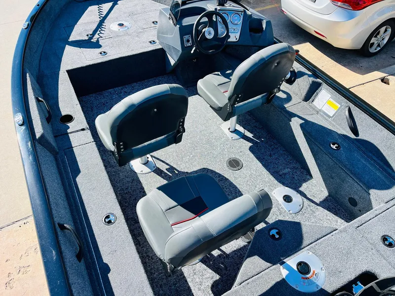 Slide: The Image of 2025 Tracker Pro Guide V-16 SC boat interior with two seats and steering console. - 16