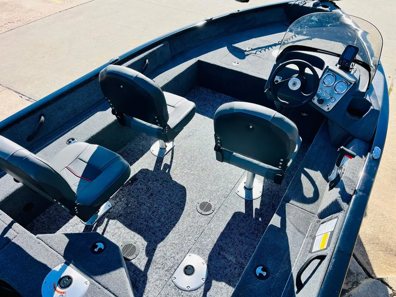 Slide: The Image of 2025 Tracker Pro Guide V-16 SC boat interior with dual seats and steering console. - 17