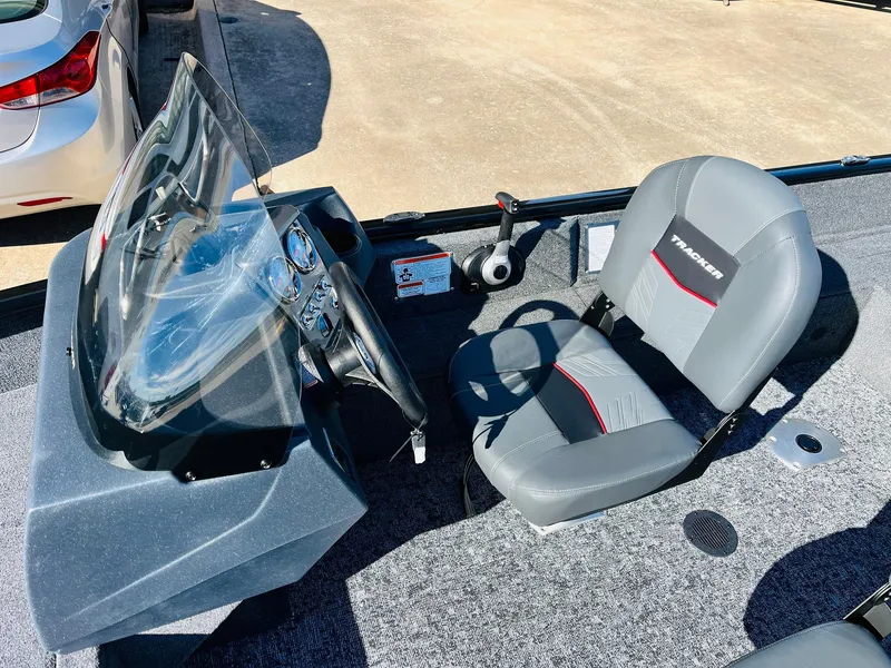 Slide: The Image of 2025 Tracker Pro Guide V-16 SC boat interior with steering console and seating. - 18
