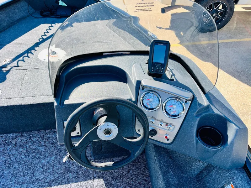 Slide: The Image of 2025 Tracker Pro Guide V-16 SC boat dashboard with steering wheel and gauges. - 19